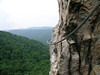 Nelson Rocks Preserve - Via Ferrata, 7/2007 : We celebrated July 4th with friends while hanging off the cliff face of Nelson Rocks Via Ferrata. This "iron way" in the Potomac Highlands of West Virginia was created in 2002 and is one of three vie ferrate in the U.S. (Via Ferrata climbing routes have long existed in some parts of the European Alps). Our able friend and guide, Tony, led us through a challenging and exhilarating afternoon of full contact activity. Steel cables and ladder rungs allow access to rocky pinnacles without technical climbing skills. Staying clipped in at all times does take a bit of concentration but this extra security also allows a few moments for enjoying the spectacular views. Nelson Rocks is an outcropping of Tuscarora sandstone near North Fork Mountain in Pendleton County, WV. Seneca Rocks, a larger and more famous rock formation, is nearby. The entire valley region includes numerous examples of similar thin towers and cliffs of rock that have resisted erosion as the surrounding Appalachian mountains softened.