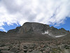 Rocky Mountain National Park, CO (8/2007) : Rocky Mountain National Park protects a vast swath of alpine terrain in the northern Colorado Rockies. Longs Peak, a famous 14er, is the centerpiece of the area at 14,259 ft. The park contains almost unimaginable alpine beauty. Dozens of stunning high mountains that tower in 5 digits above treeline, almost 100 alpine lakes, steep drainages full of waterfalls, and even a few glaciers and snowfields.  

We spent a few days exploring in the park, hiking almost 50 miles and climbing well over 10,000 vertical feet  total. Our trips took us through Glacier Gorge to its headwaters lakes; up two high mountains in the Mummy Range where Ypsilon Mountain exceeds 13,500 ft.; to the Western Continental Divide where Hallet's Peak offers a lofty 360 degree view of the entire Colorado Rockies region; and to the top of Longs Peak. Although we spent several hours every day hiking and scrambling about in the mountains, we only scratched the surface of this spectacular place. All our trips started by 6:30 a.m. so we could return below treeline before noon, a novel concept compared with our leisurely eastern start times. The reason: high-risk thunderstorms gather almost daily on Rockies afternoons. 

Climbing Longs Peak was just one of many highlights. It started at 2:30 a.m. to beat the storms and involved hiking and scrambling 15 miles round-trip with 4,870 ft. in elevation change. The final 1.5 miles involve serious rock scrambing in semi-exposed terrain. The trip went smoothly with Mark summiting in 4.5 hours at 7 a.m., as the first person to complete the Keyhole Route on August 12, 2007. Round trip took just under 10 hours. Dozens of people attempt Longs Peak each day during the two months each year the Keyhole Route is free of snow, but the park service estimates only 30% complete the trip.